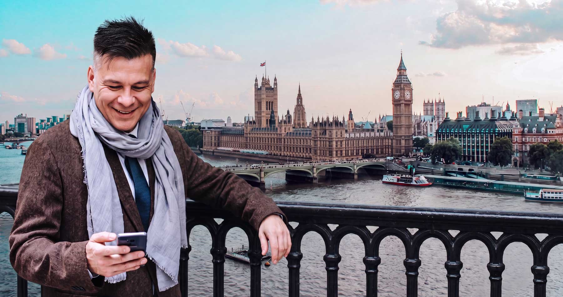 Man checking his phone on Westminster Bridge with Big Ben and the Houses of Parliament behind — short term car lease in London